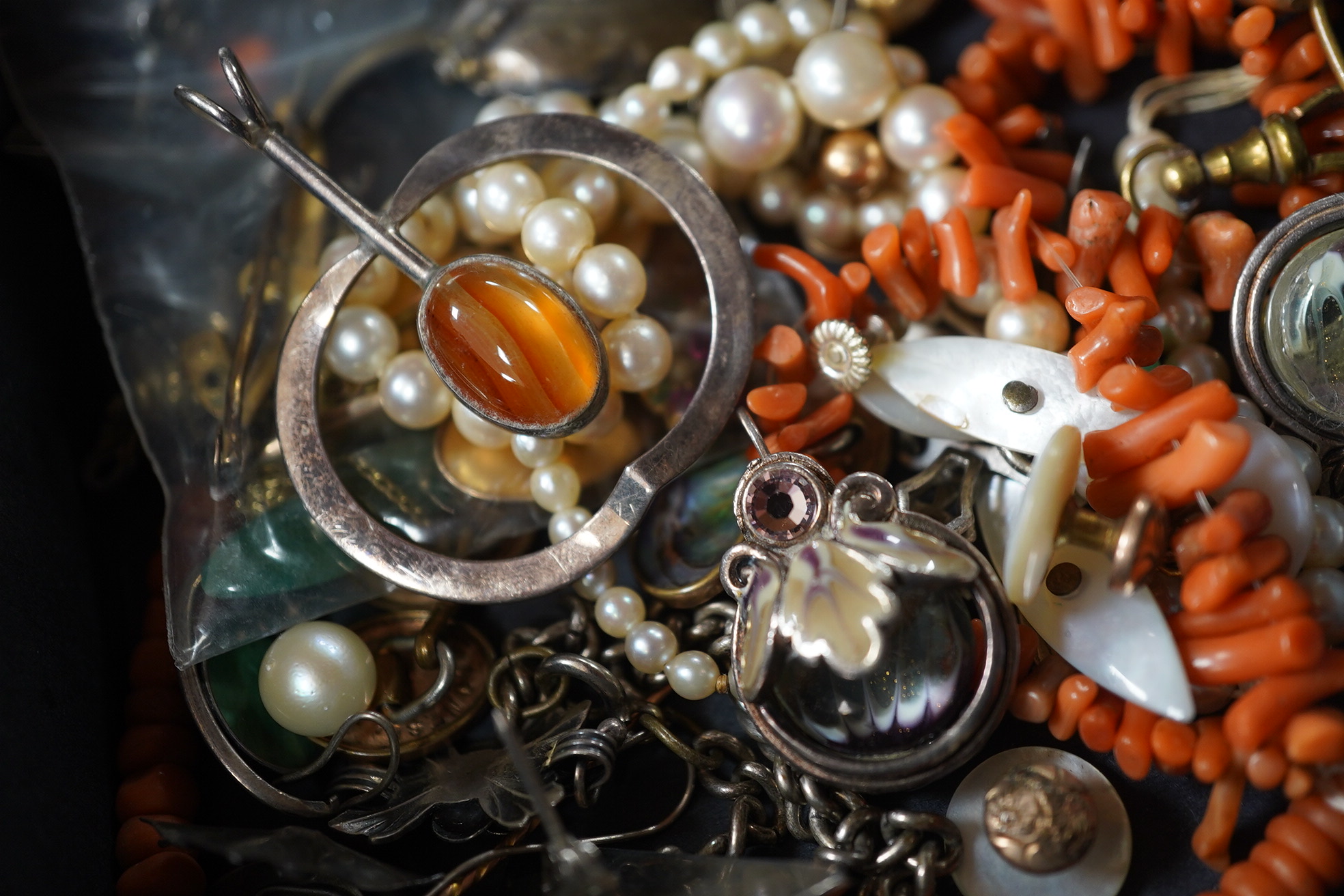 A quantity of assorted mainly costume jewellery including tortoiseshell and pique pendant, coral necklace, cultured pearl necklace, etc. Condition - poor to fair